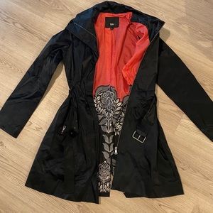 Sleak black trench coat with black belt.